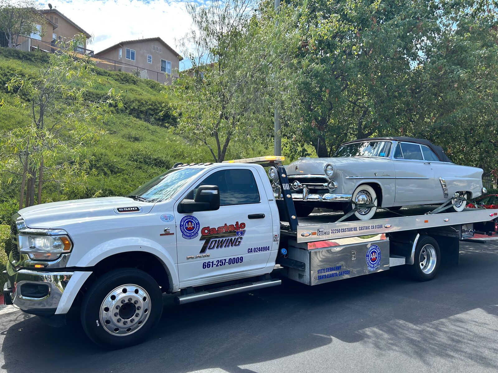 Flatbed tow truck on a Castaic hillside road